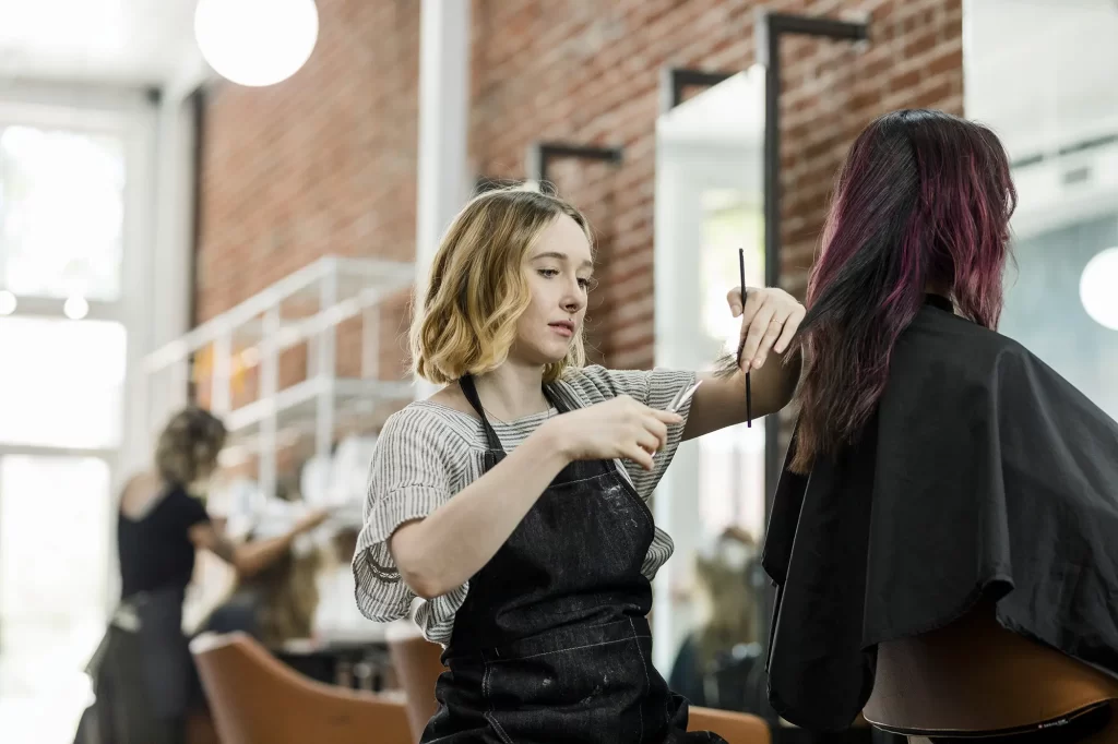 hairstylist cutting dyed hair